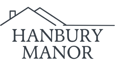A logo with a house shape above the words Hanbury Manor.